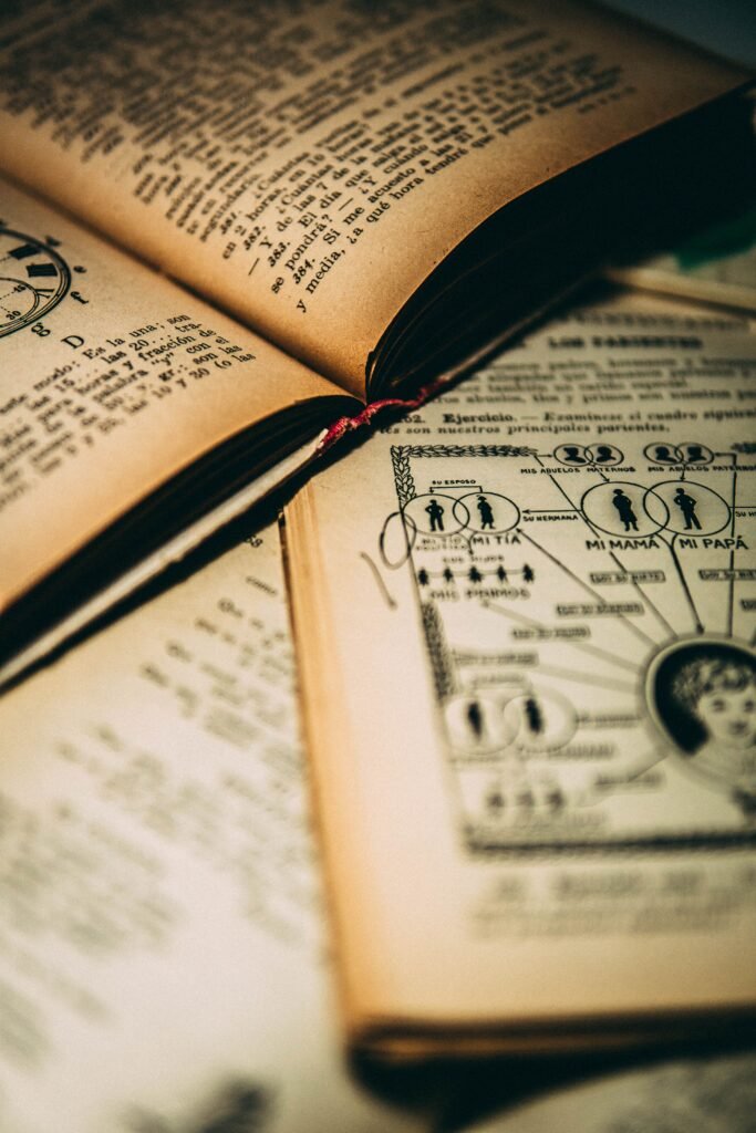 A close-up of vintage open books showing diagrams and text, evoking a retro literary feel.